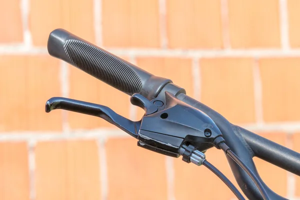 Closeup of a bicycle handlebars and brake levers, hand brake and shifter