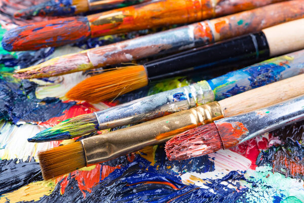 Paint brushes and paints for drawing.