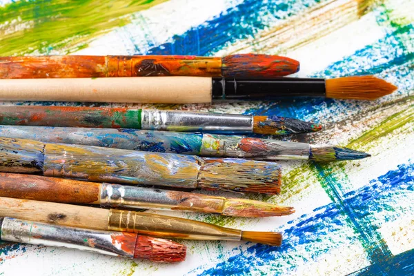 Paint brushes and paints for drawing.