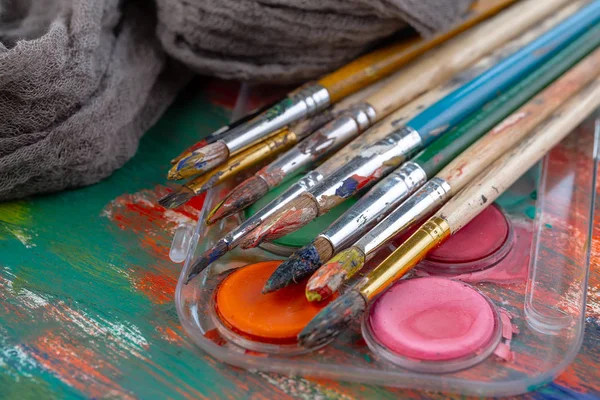 Paint brushes and paints for drawing.