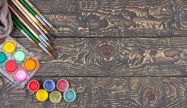 Paint brushes and paints for drawing.