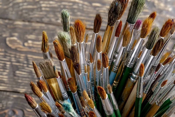 Paint brushes and paints for drawing.