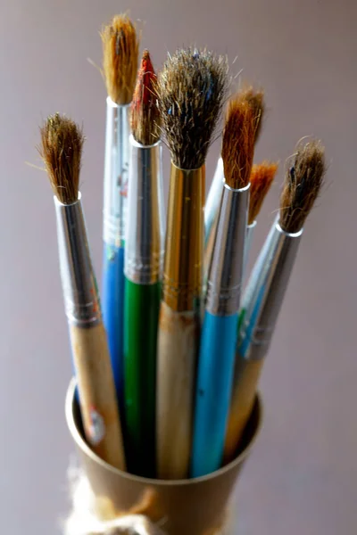 Paint brushes and paints for drawing.