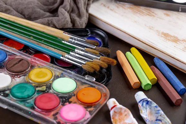 Paint brushes and paints for drawing.