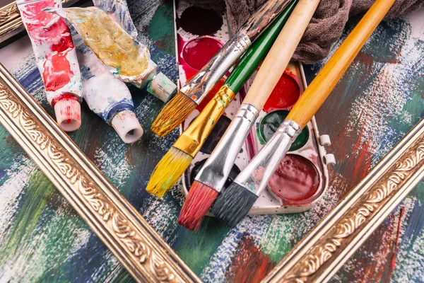 Paint brushes and paints for drawing.