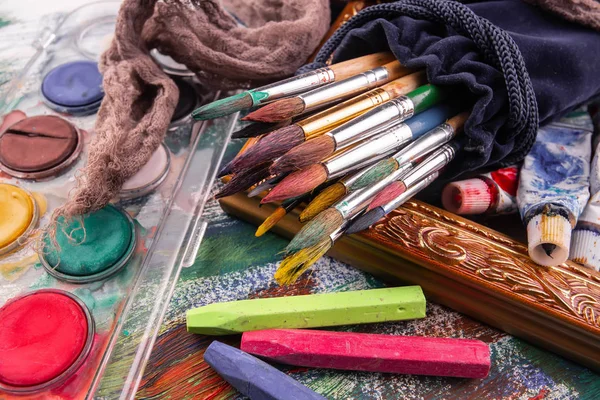 Paint brushes and paints for drawing.