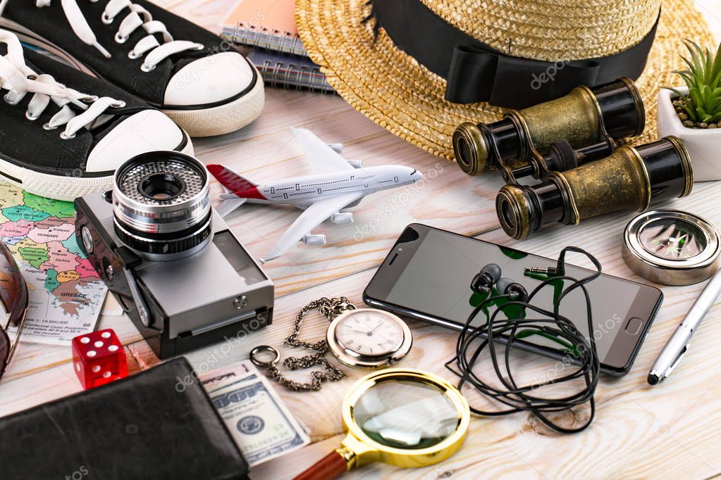 items and accessories for the traveler on the old background on the table