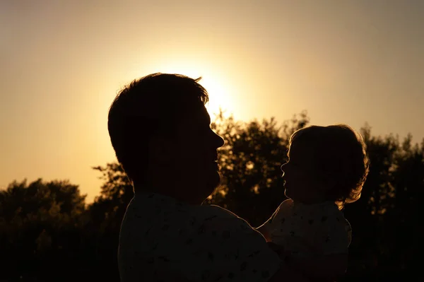 silhouette photo. Dad and son at sunset. Dad and son silhouettes. Dad and baby silhouettes