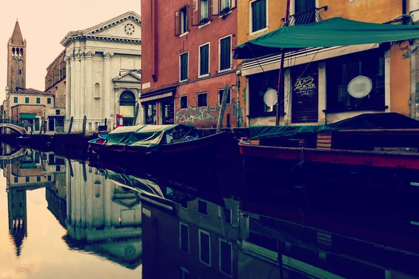 beautiful canal with boats in Venice