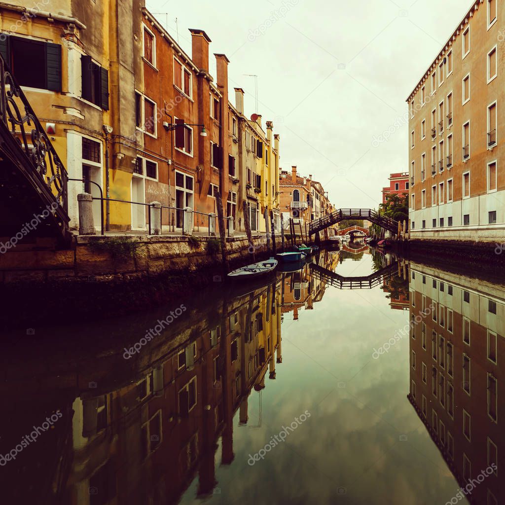 beautiful canal with boats in Venice