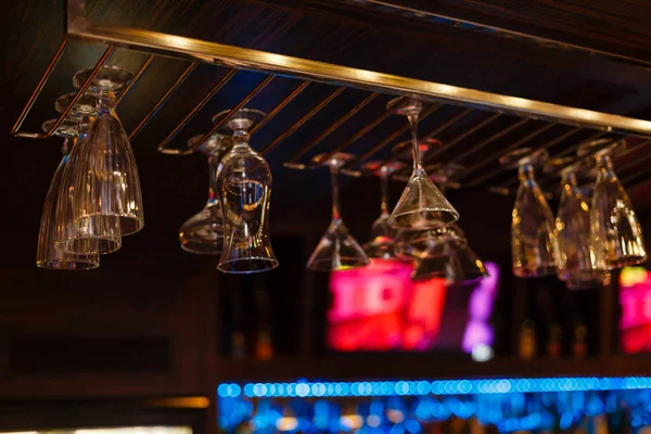 Empty glasses for wine above a bar rack in vintage tone. — Stock Image Empty Glasses Wine Bar Rack Vintage Tone Stock Photo