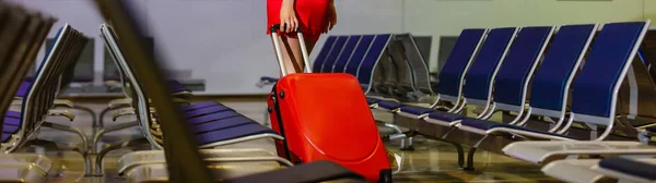 Legs of young businesswoman with baggage in airport