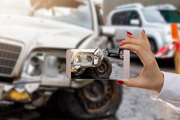 Woman using mobile smartphone take car crash accident for insurance