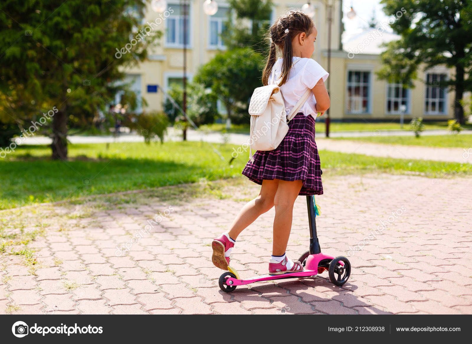 little girl riding scooter