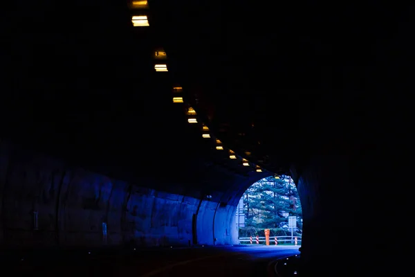Perspective View Through a Dark Tunnel With the Light at The End