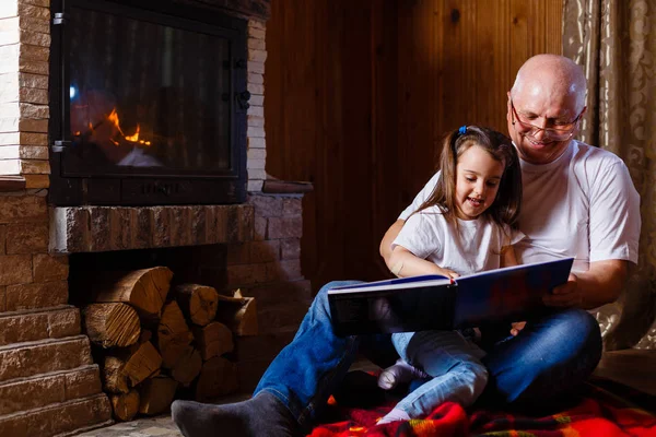 Portrait Smiling Grandfather Reading Book His Small Pretty Granddaughter Hugging — Stock Photo, Image