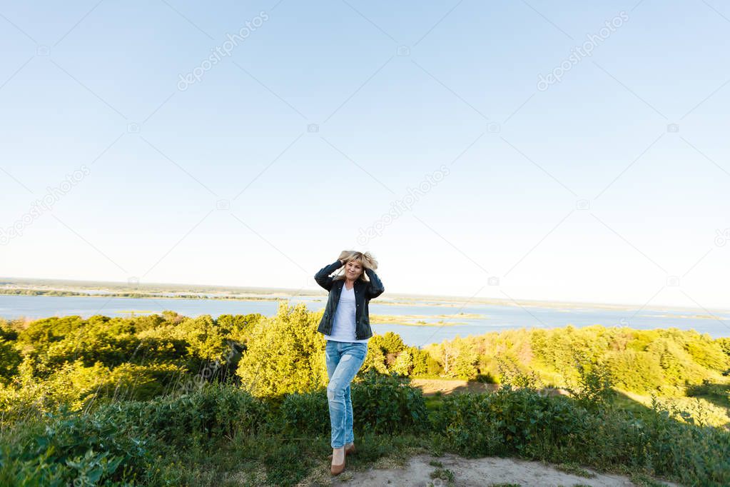 young woman looking at picturesque landscape of mountains and plains.