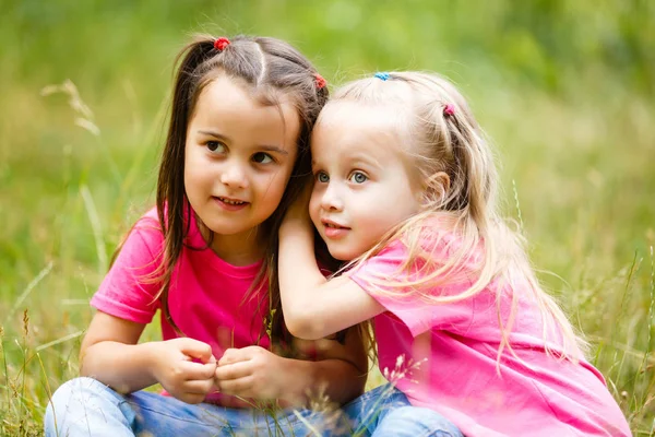 Two Little Girls Playing Sitting Green Park Grass Stock Image