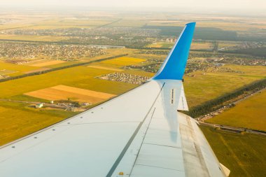 Uçak pencereden günbatımı atış çerçeveleme uçak kanat ile görüntülemek.