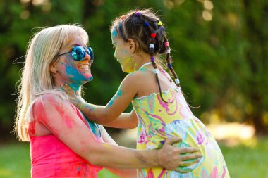 Anne ve kızı eğleniyor boyalar festivalde oynamak