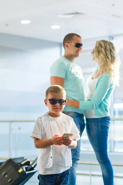 Happy family with luggage in airport ready to travel