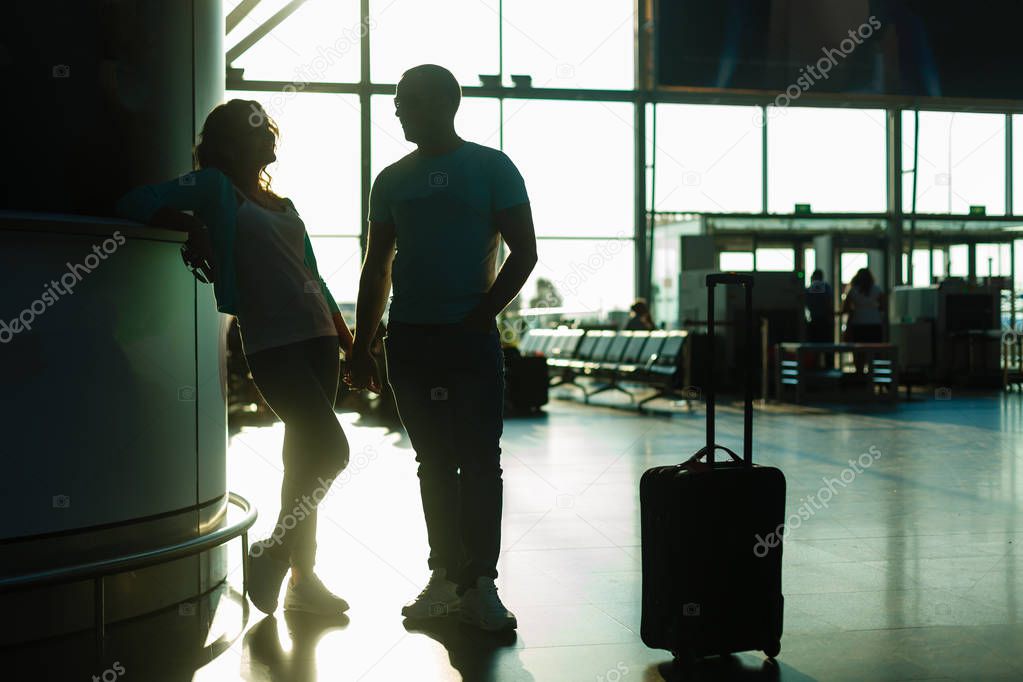 Young couple waiting for departure in airport terminal