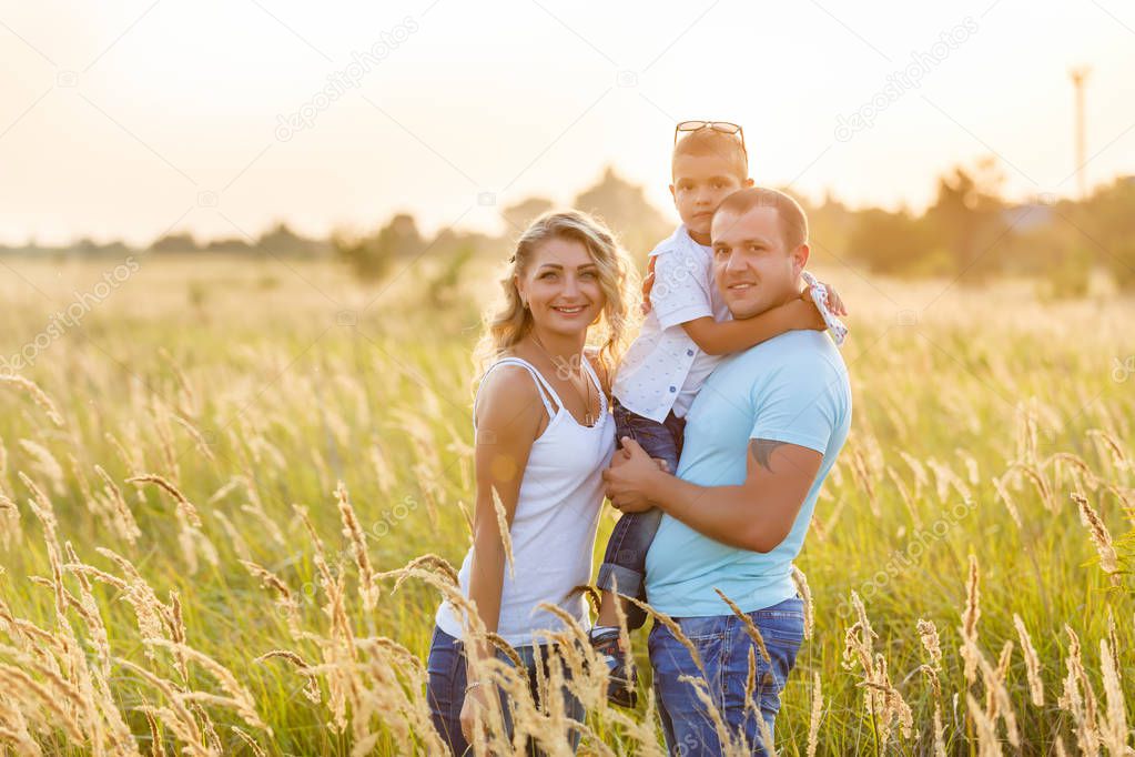 Beautiful family in a field of spikelets