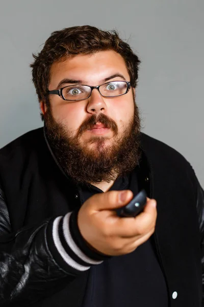 Irritated Man Holding Remote Control Try Watching Isolated Gray Background — Stock Photo, Image