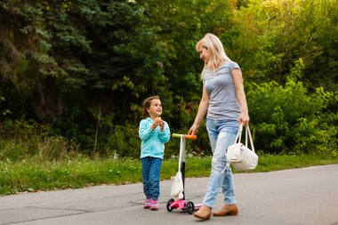Mother And Daughter Walking Along Path clipart