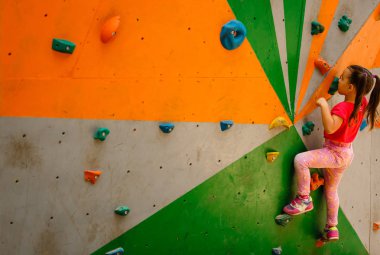 Sport image of climbing little girls to the top of wall clipart