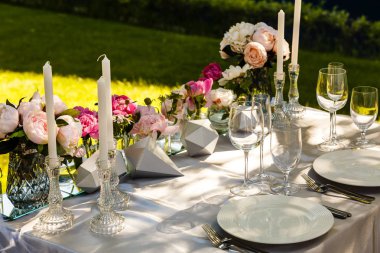 Beyaz ve pembe şakayıkile düğün masası dekorunun yakın görünümü 