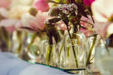 Beyaz ve pembe şakayıkile düğün masası dekorunun yakın görünümü 