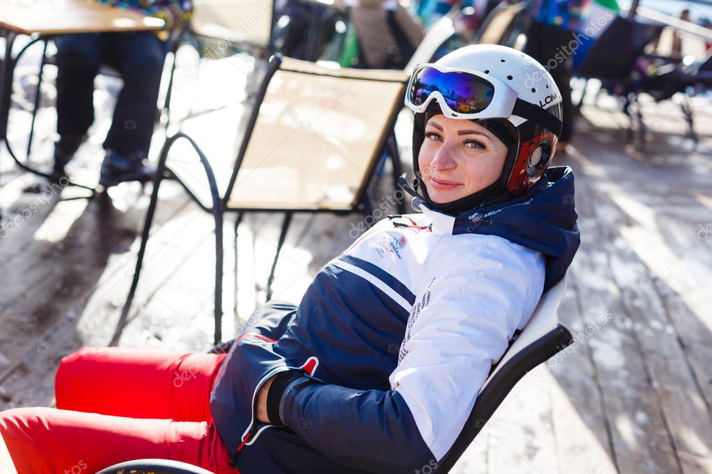 Young woman resting after skiing on terrace 