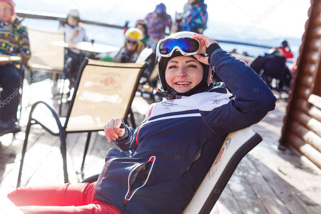 Young woman resting after skiing on terrace 