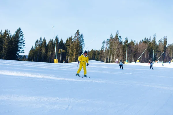 Woman Yellow Winter Jumpsuit Riding Skis Snowy Mountains — Stock Photo, Image