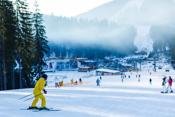 Woman Yellow Winter Jumpsuit Riding Skis Snowy Mountains — Stock Photo, Image