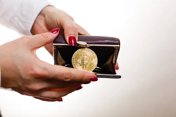 female hands holding open wallet with bitcoin