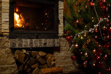 Şömine nin yanında dekore edilmiş Noel ağacının yakın görünümü