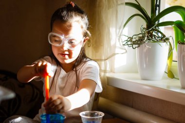 Küçük kız koruyucu gözlük ile İlköğretim Fen Bilgisi dersinde deney