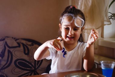 Küçük kız koruyucu gözlük ile İlköğretim Fen Bilgisi dersinde deney
