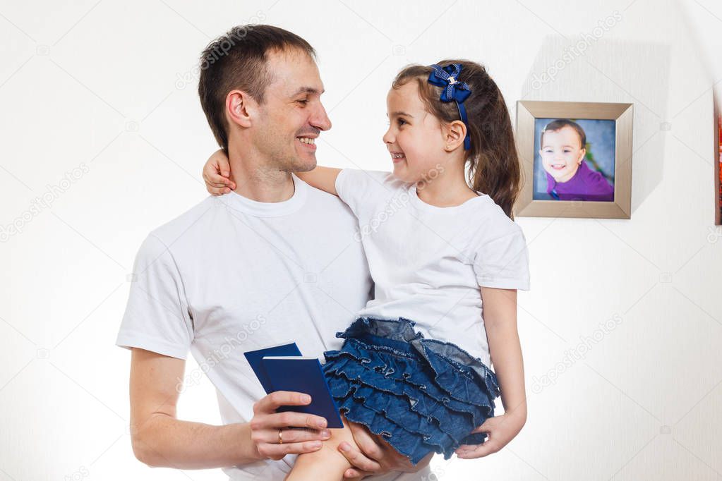 Smiling father with passports and daughter isolated on white background 