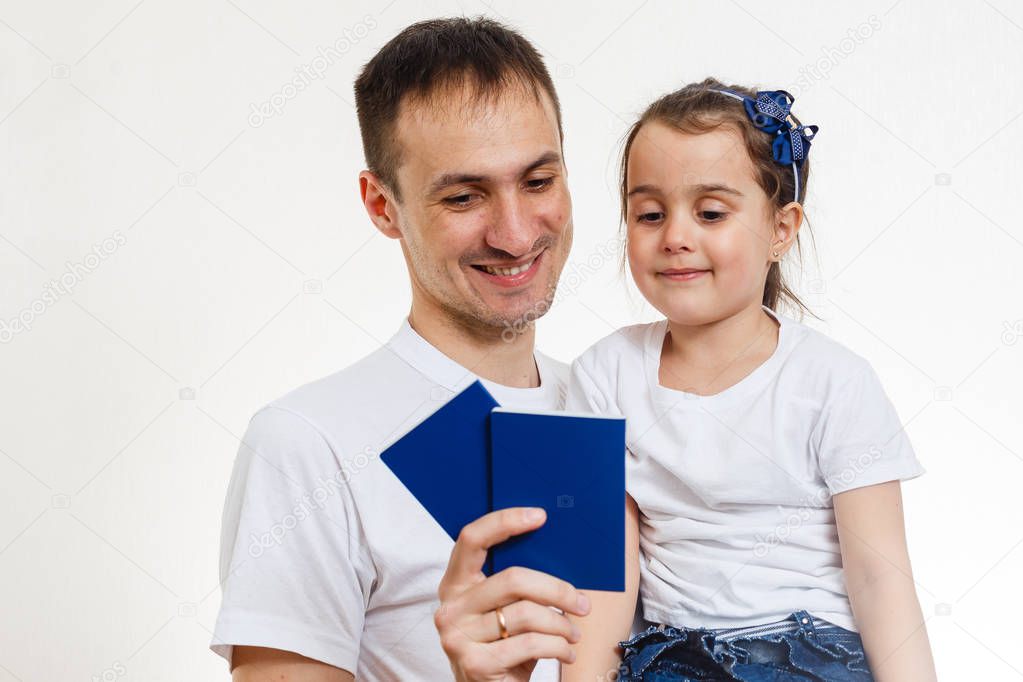 Smiling father with passports and daughter isolated on white background 
