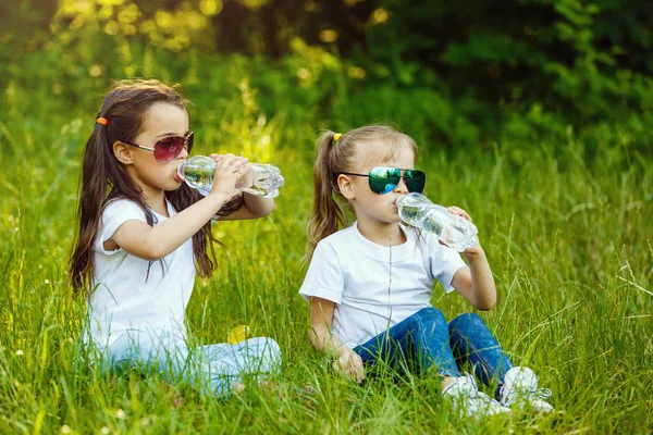 Dvě Malé Holčičky Popíjejí Vodu Zeleném Parku — Stock fotografie