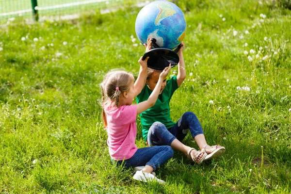 Two Little Schoolgirls Sitting Grass Globe — Stock Photo, Image