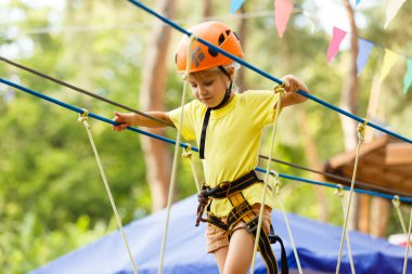 Küçük kız aşırı parkta halatlar üzerinde tırmanma 