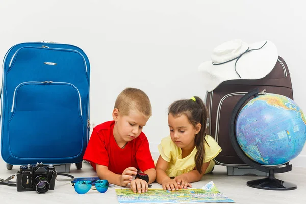 little children with suitcases, dollars and globe on white background, travel concept