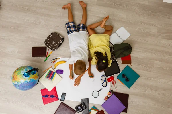 Preschool boy and girl playing on floor with educational toys