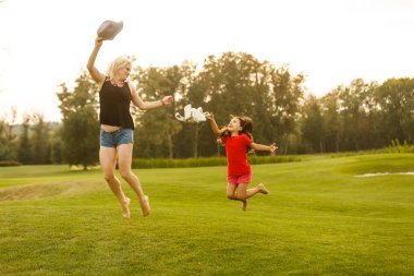 Genç anne kızıyla bahar parkında vakit geçiriyor.