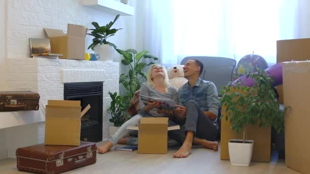 Young Couple Laughing Family Album While Sitting Floor Fireplace Home — Stock Video