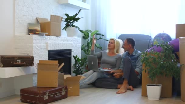 Young Couple Using Laptop Talking While Sitting Floor Fireplace Home — Stock Video